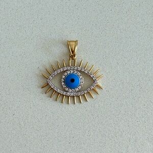 14k solid yellow gold evil eye pedant. It is a gift and size is too big for me.